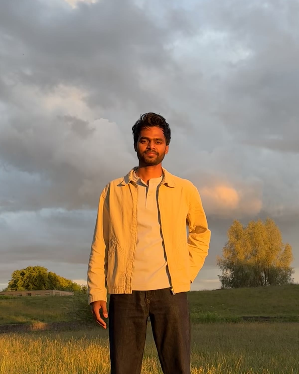 Pratik Ingle standing outdoors in warm evening light