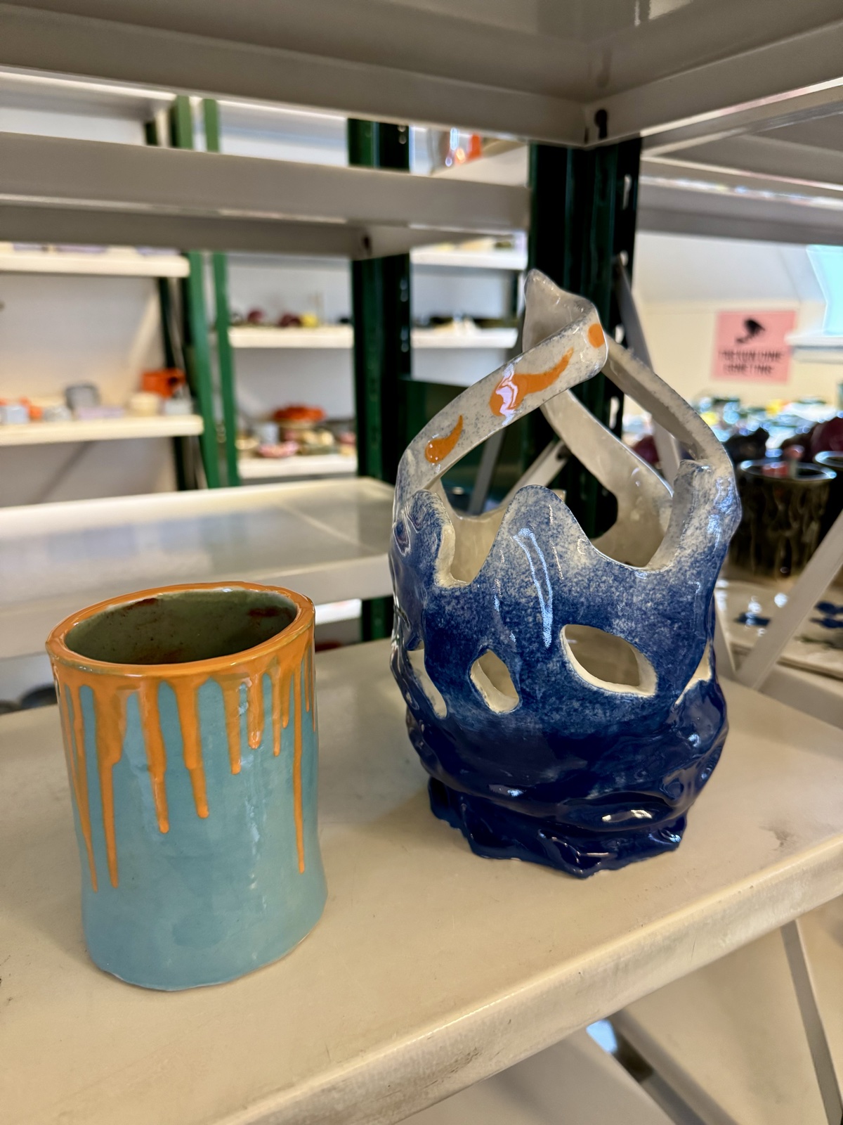 two glazed ceramic pieces on a studio table