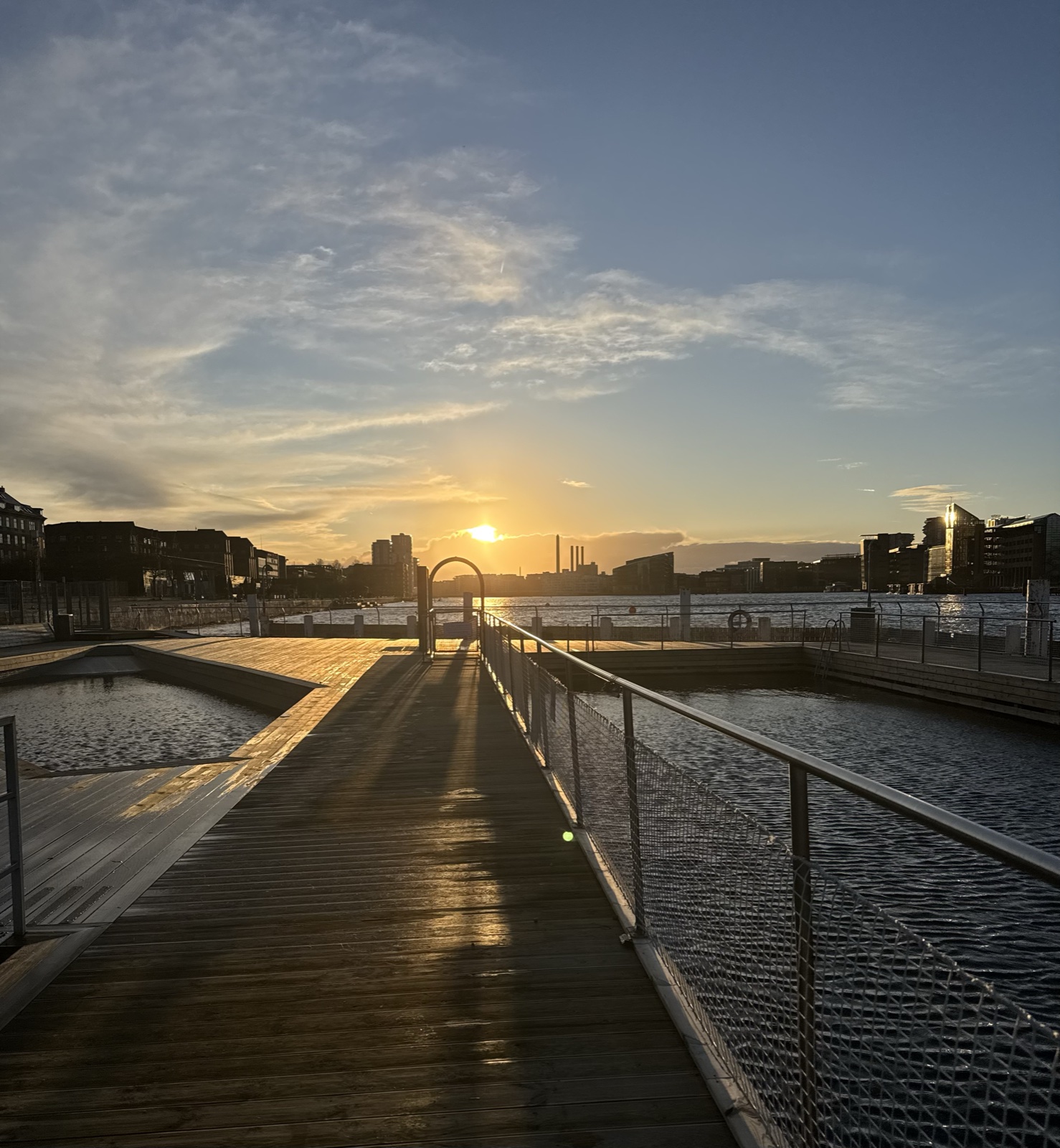 the sun low over a bathing jetty